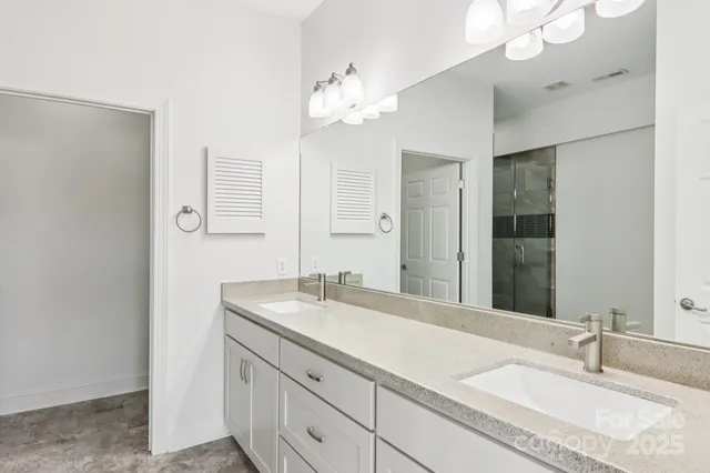 a bathroom with a sink vanity and a mirror