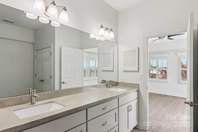 a bathroom with a sink double vanity and a mirror