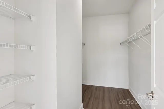 a view of walk in closet with empty racks