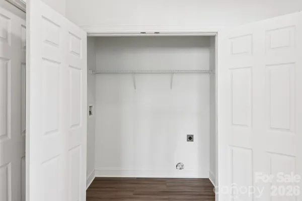 a view of walk in closet with wooden floor