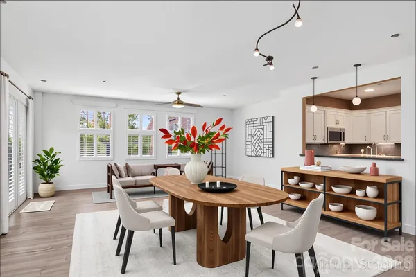 a view of a dining room with furniture kitchen and wooden floor