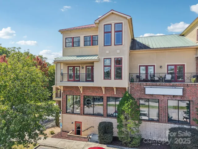 a front view of a residential apartment building with a yard