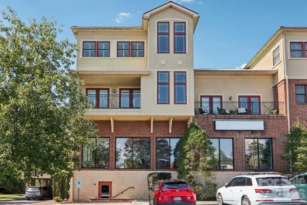 a front view of a residential apartment building with a yard
