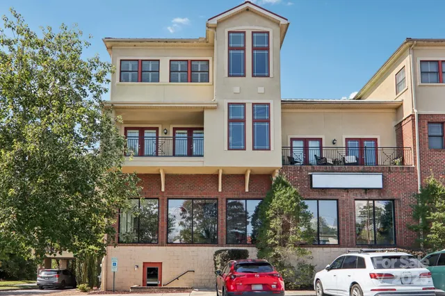 a front view of a residential apartment building with a yard
