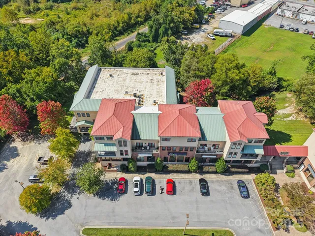 an aerial view of residential houses and car parked
