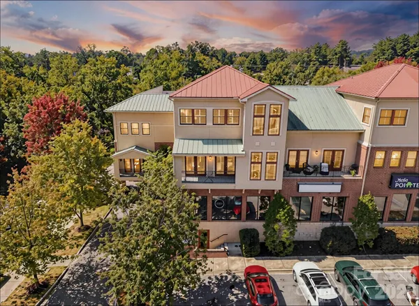 a aerial view of a brick house next to a yard