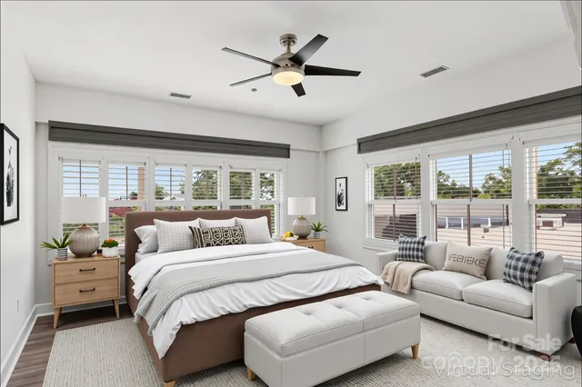 a bedroom with a large bed and a large window