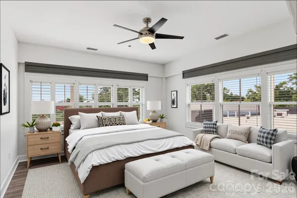 a bedroom with a large bed and a large window