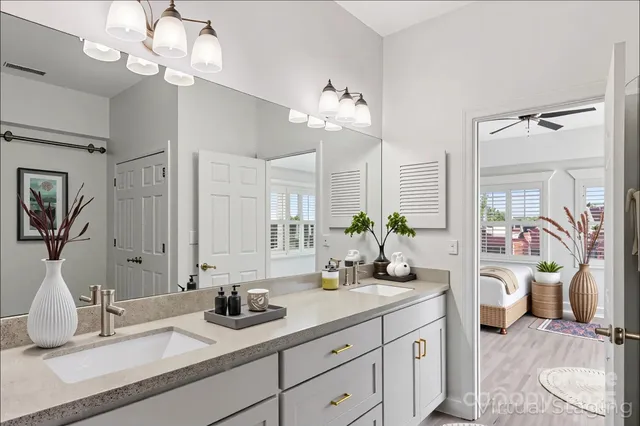 a bathroom with a sink double vanity granite and a mirror