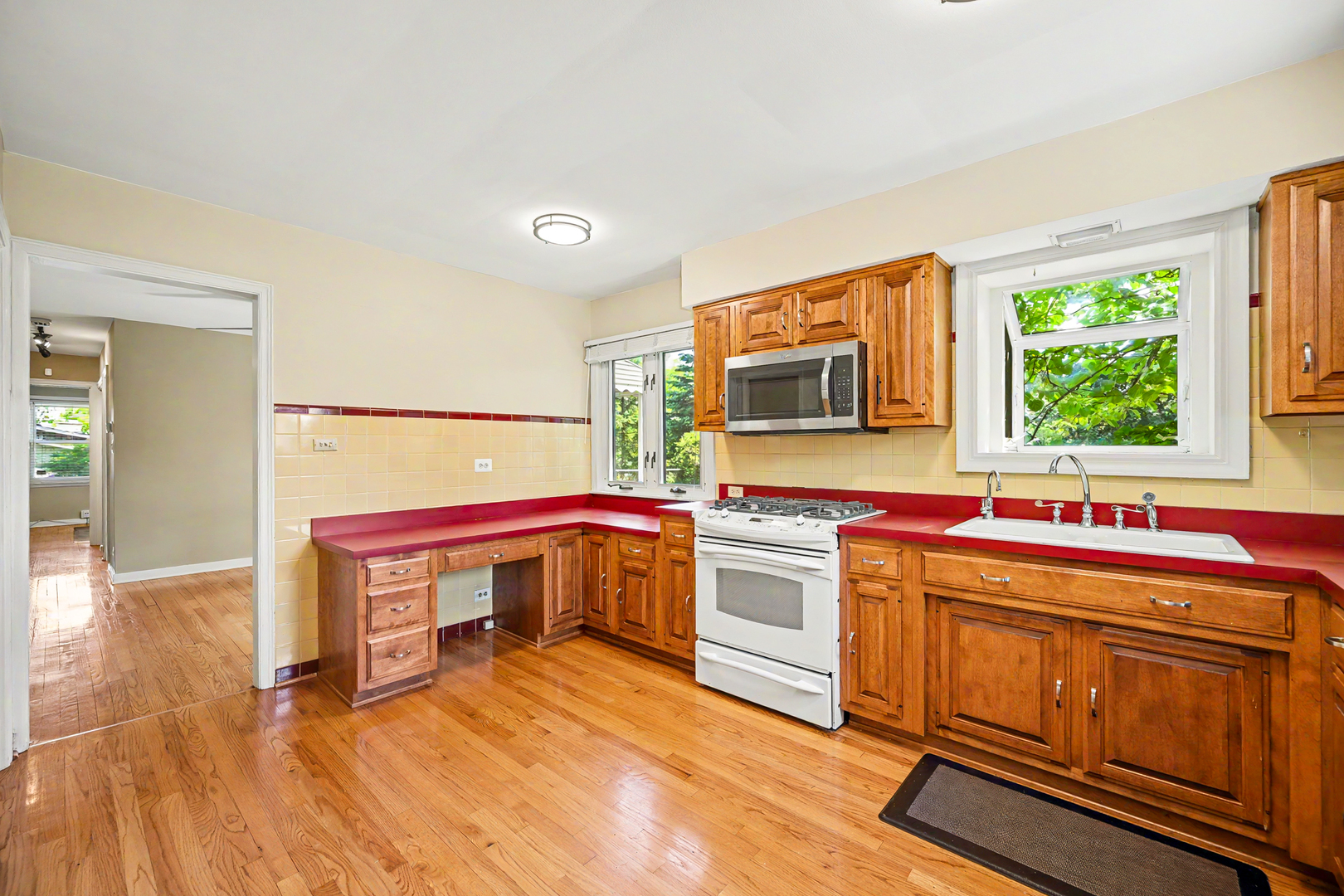 325 South Lambert Road Glen Ellyn, IL 60137 - Photo 15 of 32 a kitchen with stainless steel appliances a stove a sink dishwasher and cabinets with wooden floor