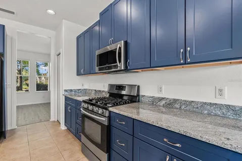 a kitchen with granite countertop stainless steel appliances a cabinets and a counter space