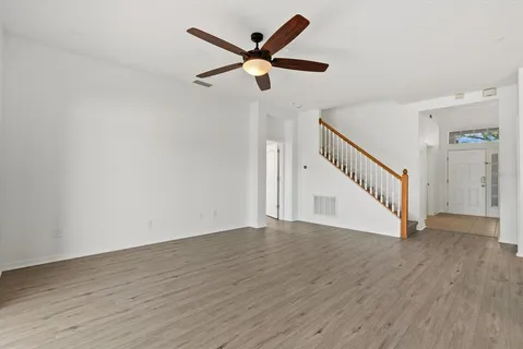 a view of an empty room with wooden floor