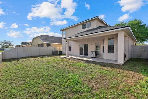 a view of a house with backyard