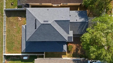 an aerial view of a house with a yard