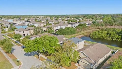 an aerial view of residential houses with outdoor space and river