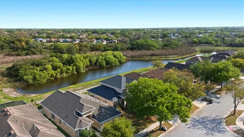 an aerial view of residential houses with outdoor space and river