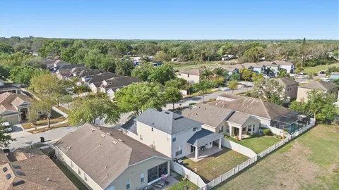 an aerial view of residential houses with outdoor space and city view