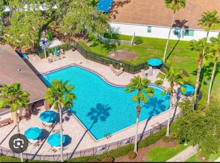 an aerial view of a house yard and swimming pool