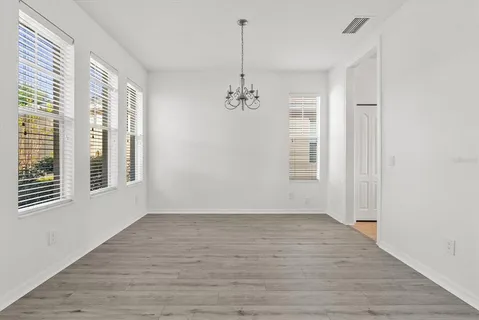 a view of a room with wooden floor and windows