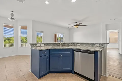a kitchen with granite countertop a sink stainless steel appliances and cabinets
