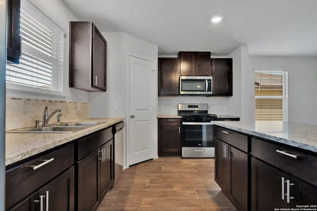 a kitchen with a sink stove and microwave