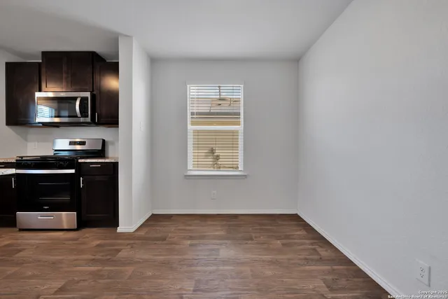 a view of a kitchen with a sink and a window