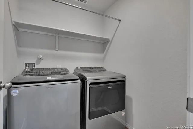 a view of storage and utility room with washer and dryer