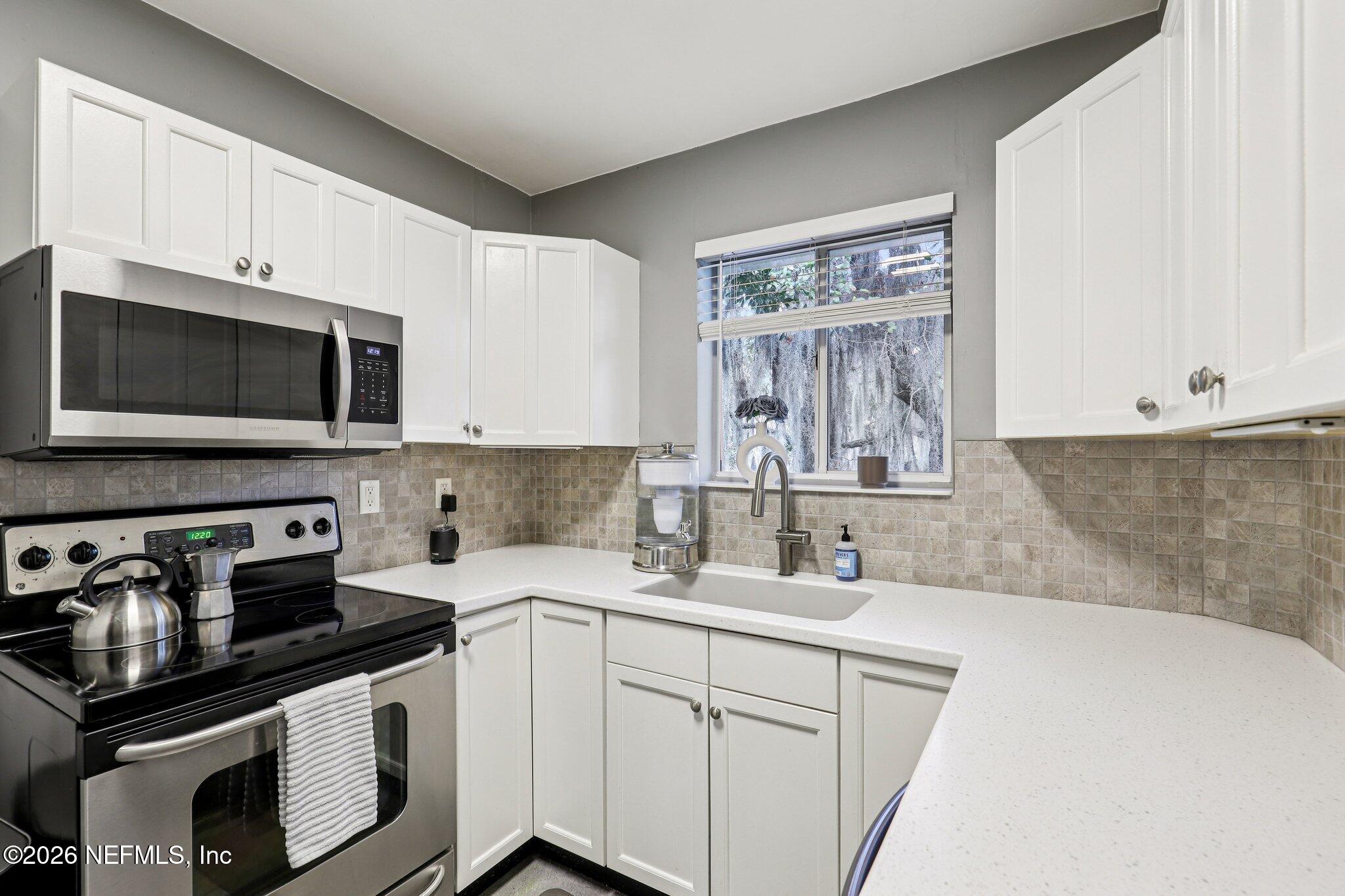 2159 Riverside Avenue, Unit 4 Jacksonville, FL 32204 - Photo 16 of 50 a kitchen with stainless steel appliances a sink a stove and microwave