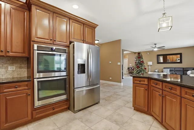 a kitchen with granite countertop a refrigerator and a sink