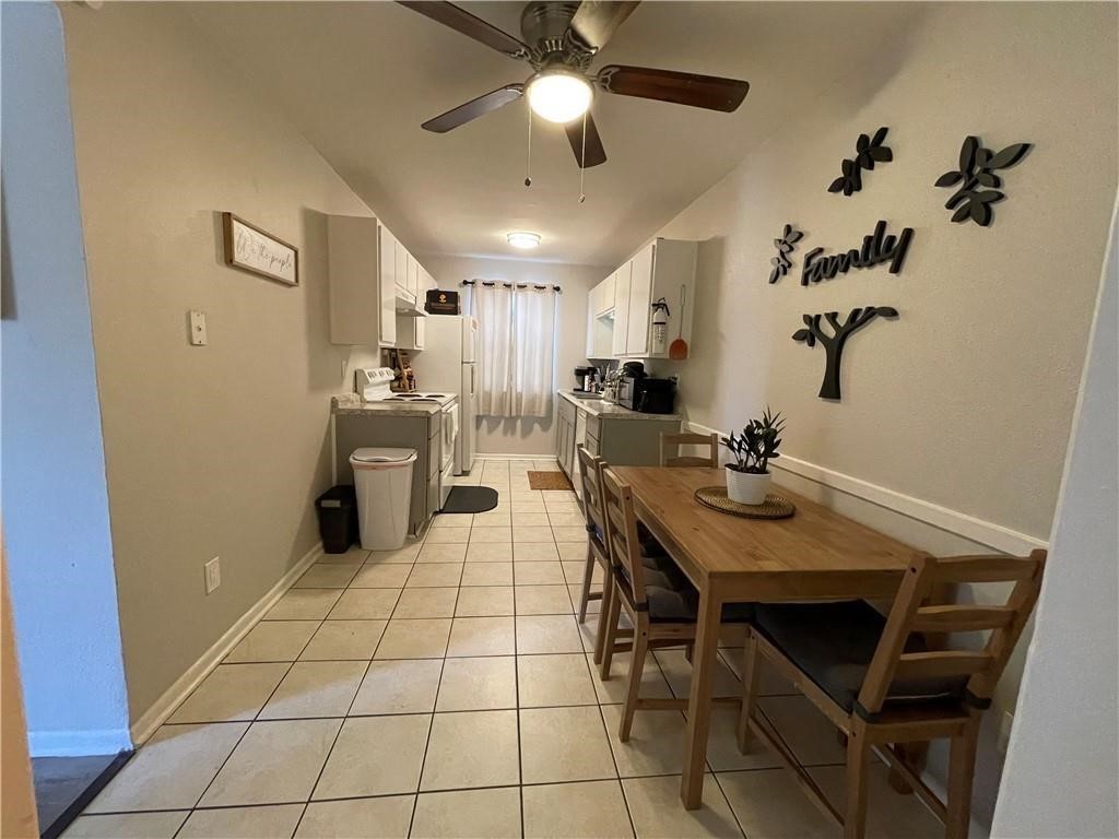 4302 Lake Road, Unit 4 Killeen, TX 76543 - Photo 2 of 9 Dining area featuring light tile patterned flooring, ceiling fan, and sink
