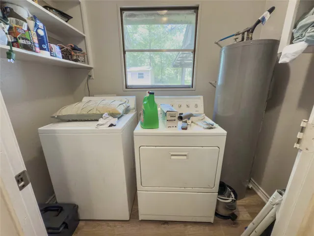 a view of a house with a large tree and a yard