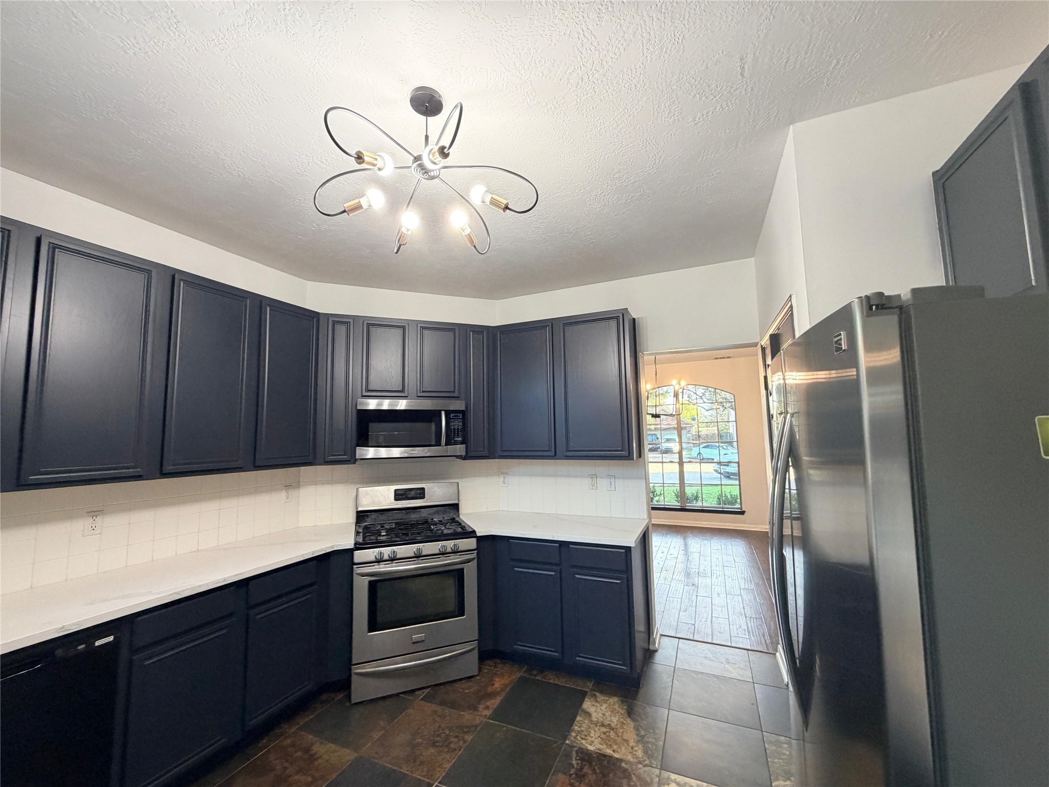13002 Bainbridge Trail Houston, TX 77065 - Photo 13 of 32 a kitchen with granite countertop stainless steel appliances and a refrigerator