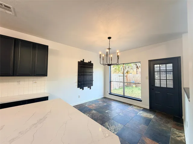 a view of an empty room with a fireplace and a window