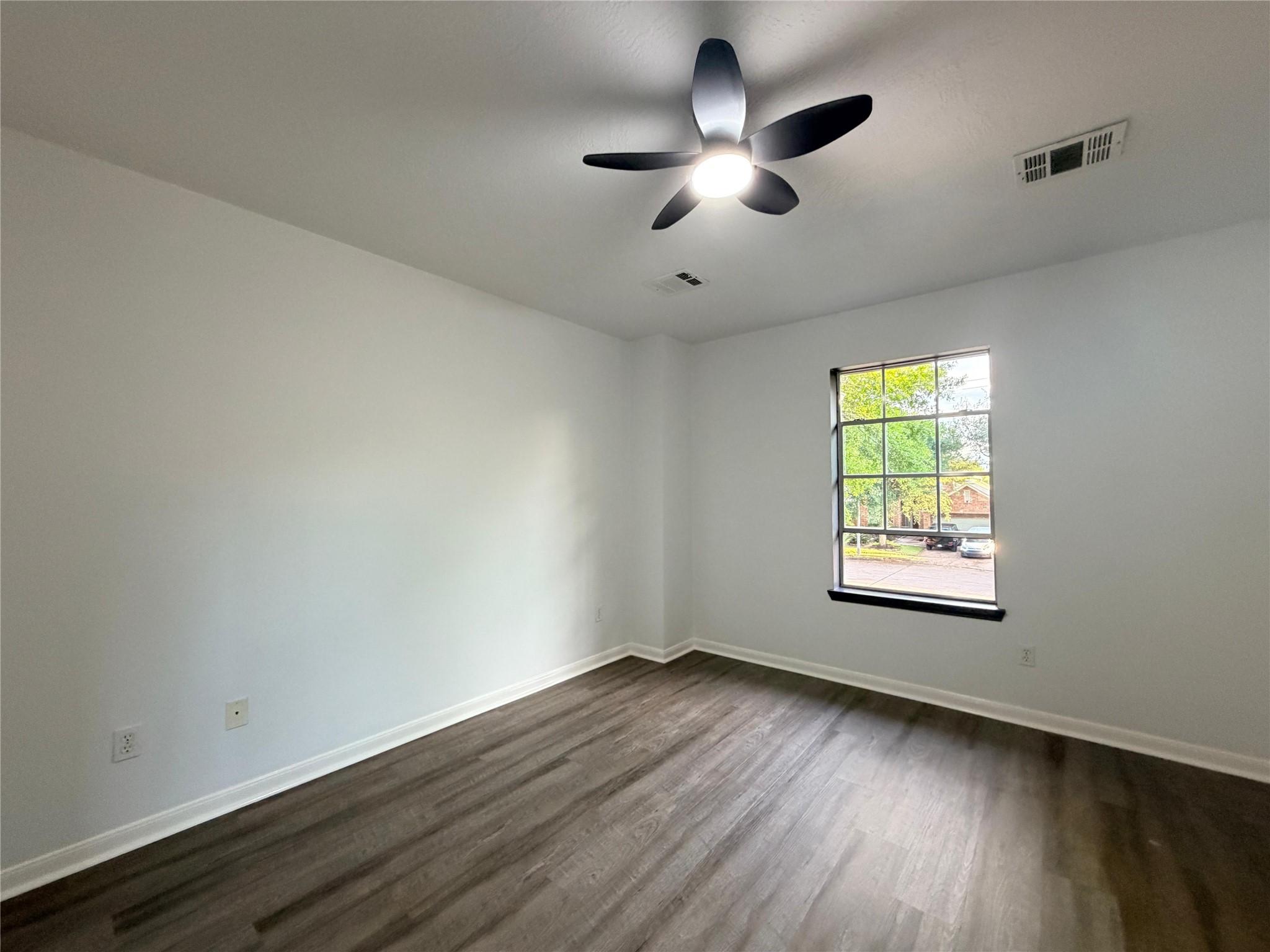 13002 Bainbridge Trail Houston, TX 77065 - Photo 21 of 32 an empty room with wooden floor and windows