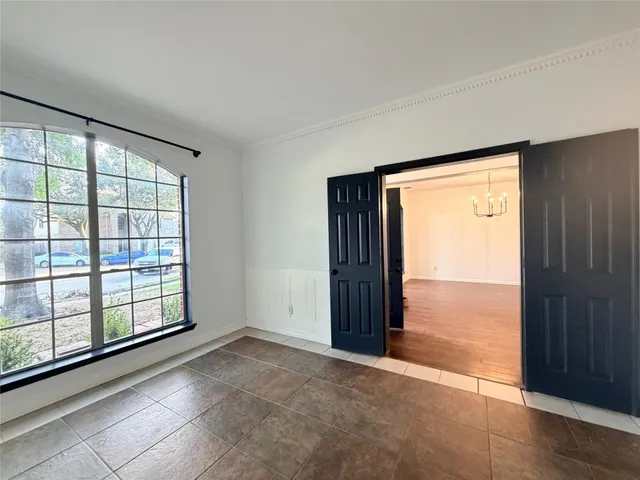a view of an empty room with glass door