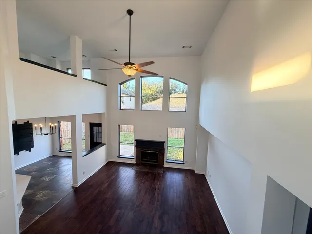 a view of a livingroom with a fireplace and window