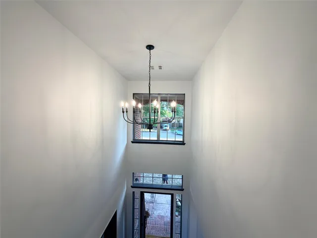 a room with a window and a chandelier