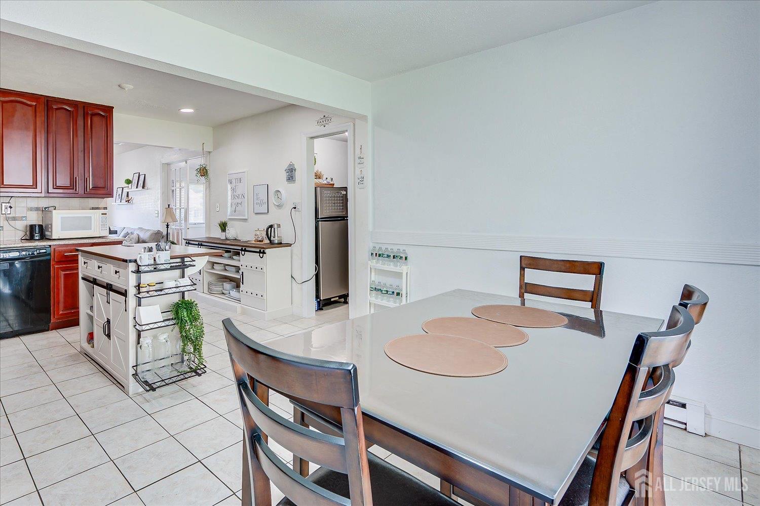 15 Markham Road Edison, NJ 08817 - Photo 12 of 32 a kitchen with stainless steel appliances granite countertop a stove a refrigerator a sink a dining table and chairs