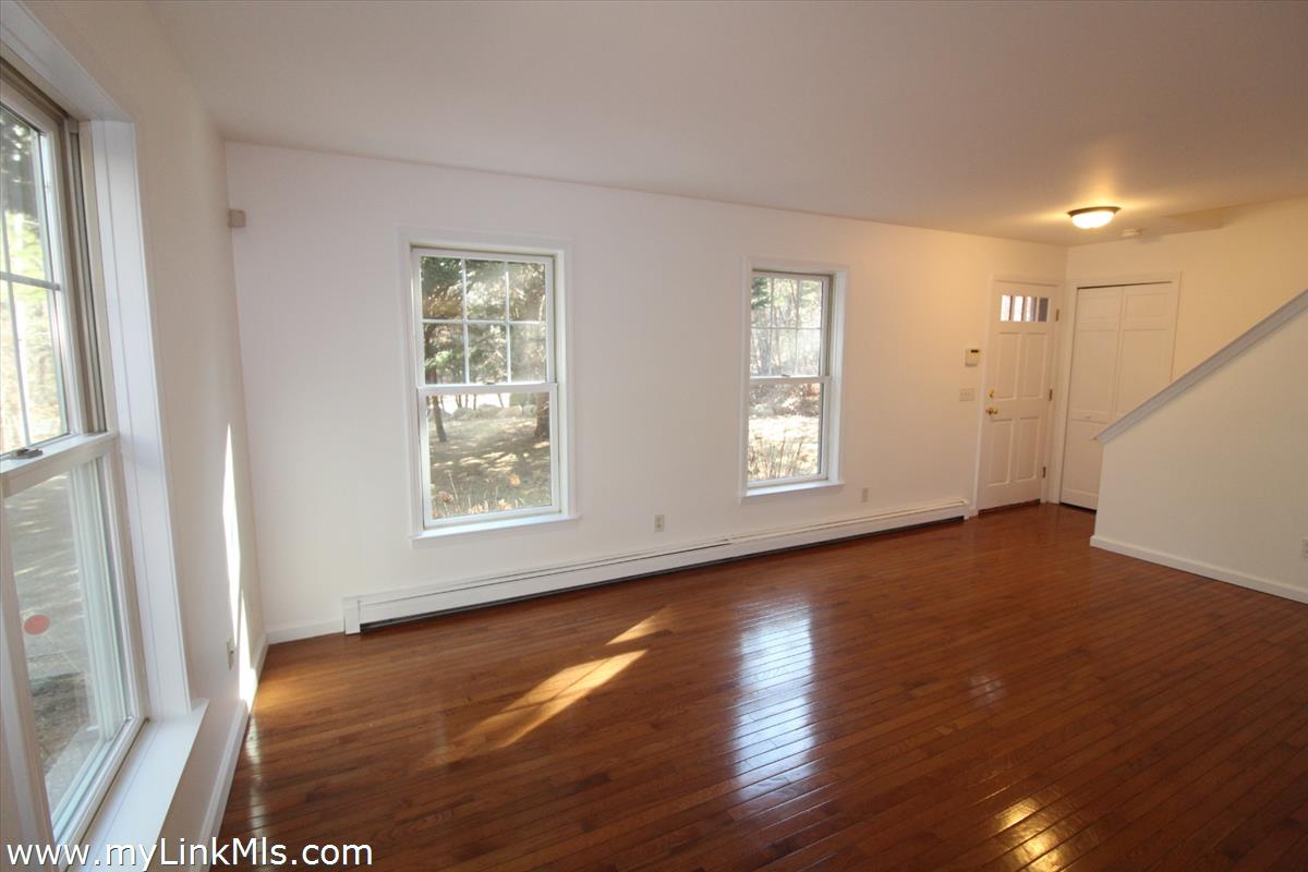 11 Flamingo Drive Edgartown, MA 02539 - Photo 6 of 25 a view of an empty room with wooden floor and a window
