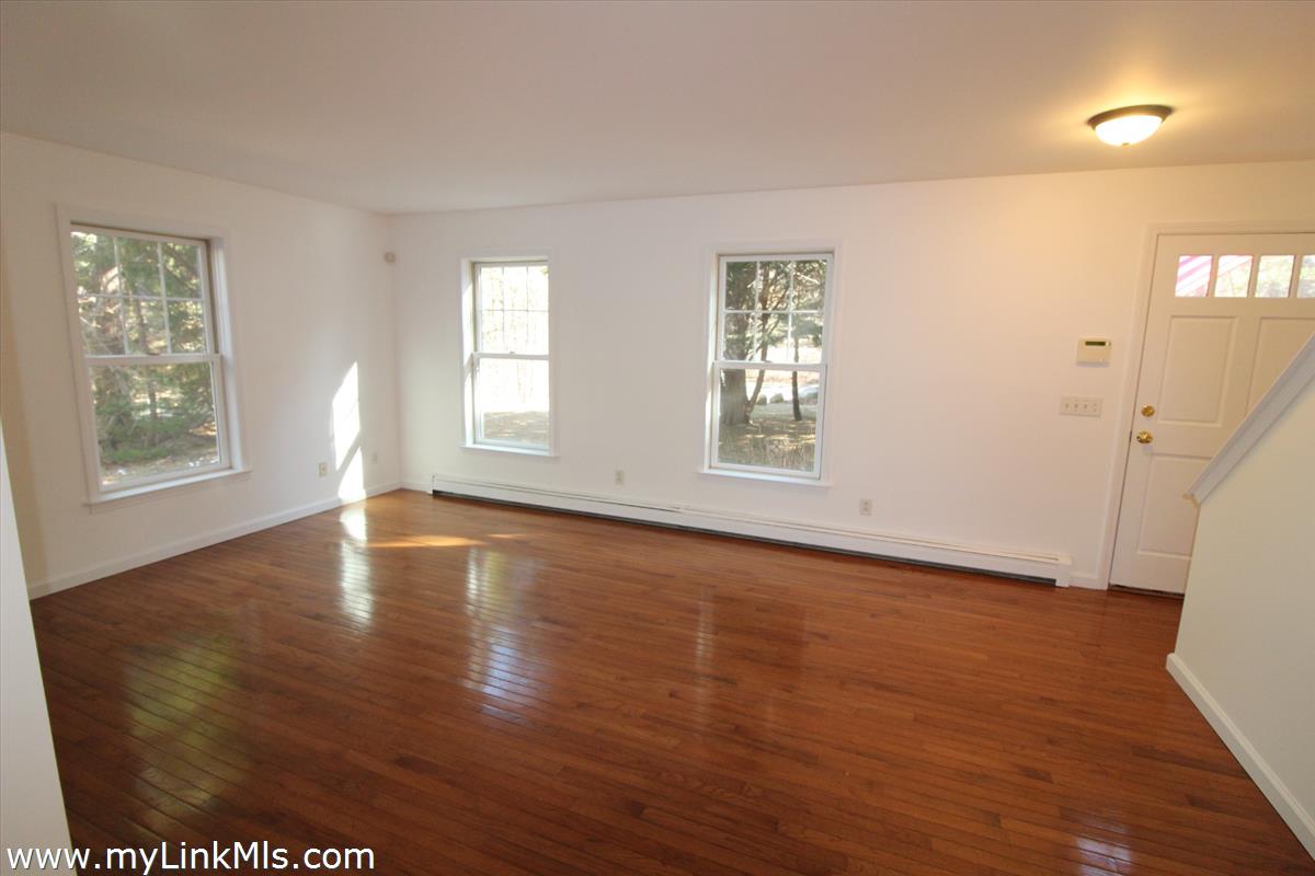 11 Flamingo Drive Edgartown, MA 02539 - Photo 7 of 25 an empty room with wooden floor and windows