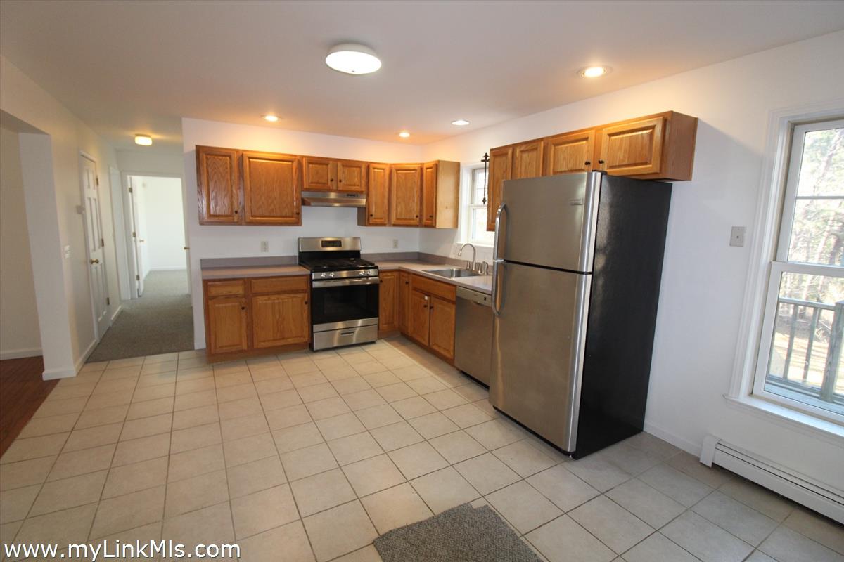 11 Flamingo Drive Edgartown, MA 02539 - Photo 8 of 25 a kitchen with stainless steel appliances granite countertop a refrigerator sink and stove