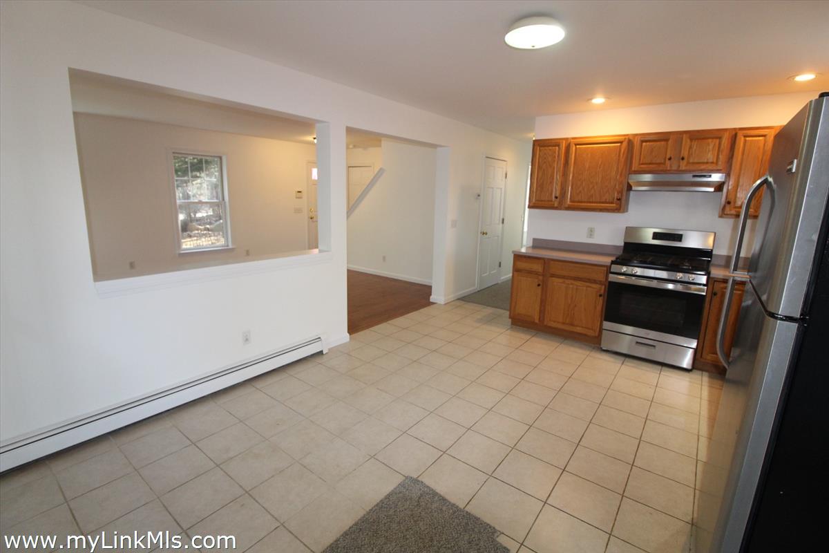 11 Flamingo Drive Edgartown, MA 02539 - Photo 9 of 25 a kitchen with stainless steel appliances a refrigerator and microwave
