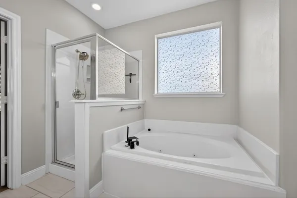 a bathroom with a bathtub and a shower