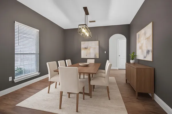 a view of a dining room with furniture window and wooden floor