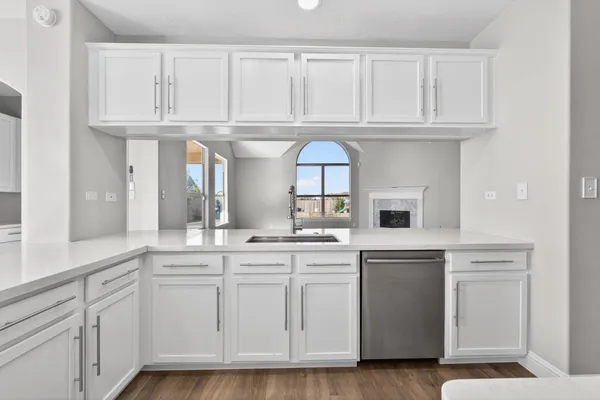 a kitchen with white cabinets and a sink