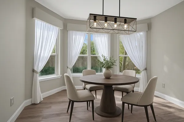 a view of a dining room with furniture window and wooden floor