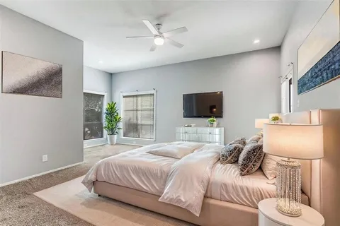 a bedroom with a bed and a flat screen tv