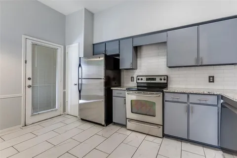 a kitchen with cabinets stainless steel appliances and a sink
