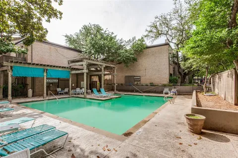 a front view of a house with swimming pool having outdoor seating