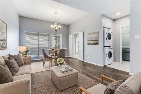 a living room with furniture and a chandelier
